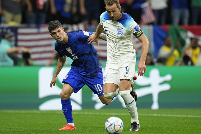 England's Harry Kane, right, fights for the ball against Christian Pulisic of the United States during the World Cup group B soccer match at the Al Bayt Stadium in Al Khor, Qatar, on Friday.