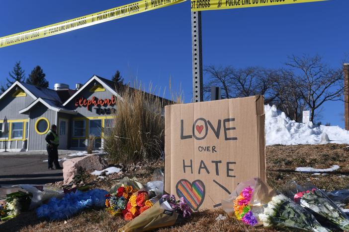 Bouquets of flowers are left near Club Q, an LGBTQ nightclub in Colorado Springs, Colorado. At least five people were killed and 18 wounded in a mass shooting at an LGBTQ nightclub in the US city of Colorado Springs, police said on November 20, 2022.