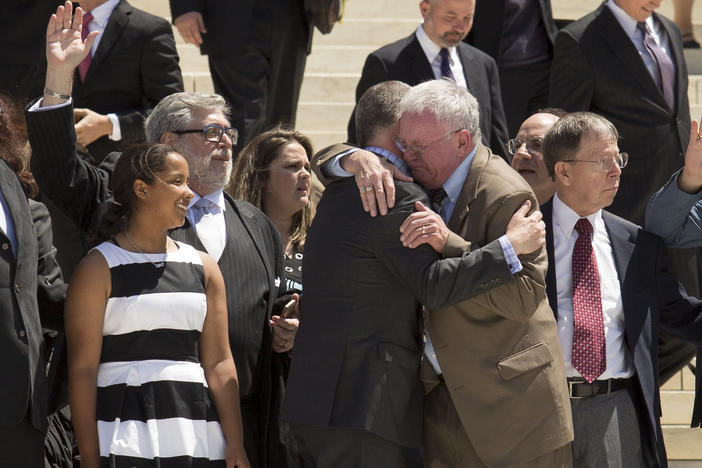 Jim Obergefell and fellow plaintiff Luke Barlowe hug as they exit the Supreme Court on April 28, 2015 after oral arguments concerning whether same-sex marriage is a constitutional right.