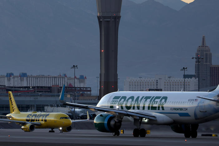 A Frontier Airlines plane  prepares to take off from Harry Reid International Airport in Las Vegas, Nevada.