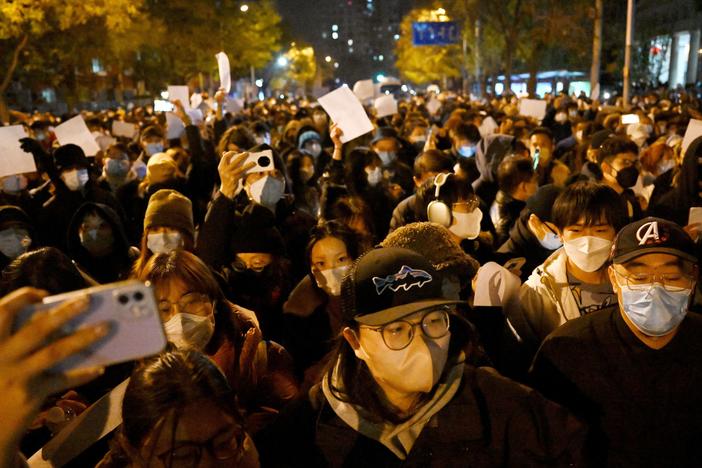 Protesters march in Beijing at a rally for the victims of a deadly fire as well as a protest against China's harsh COVID-19 restrictions early Monday.