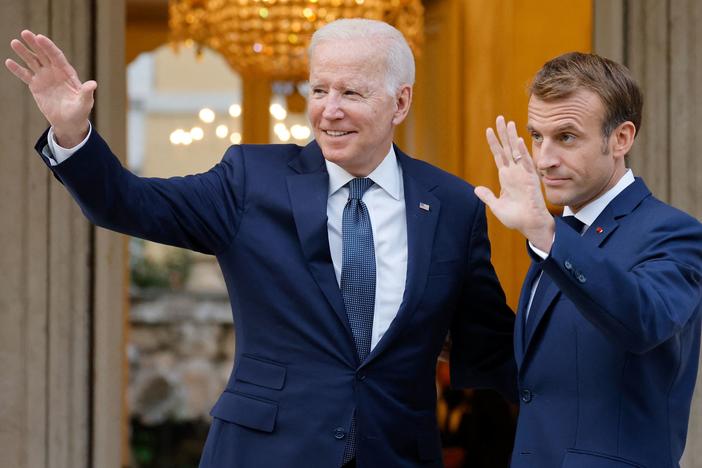 French President Emmanuel Macron welcomes President Biden before their meeting at the French Embassy to the Vatican in Rome on Oct. 29, 2021.