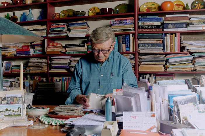 Donald Brown organizes postcards inside his home in Myerstown, Pa., on June 24, 2022.
