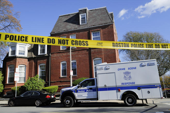 A Boston Police Crime Scene Response vehicle is parked on the street outside an apartment building where infant and other human remains were discovered by authorities.