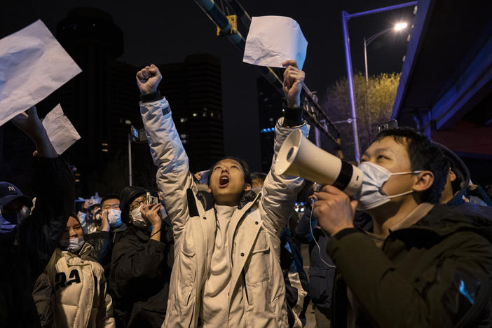 Protesters shout slogans during a protest against China's strict coronavirus measures on Monday in Beijing, China. Protesters took to the streets in multiple Chinese cities after a deadly apartment fire in Xinjiang province sparked a national outcry as many blamed COVID-19 restrictions for the deaths.