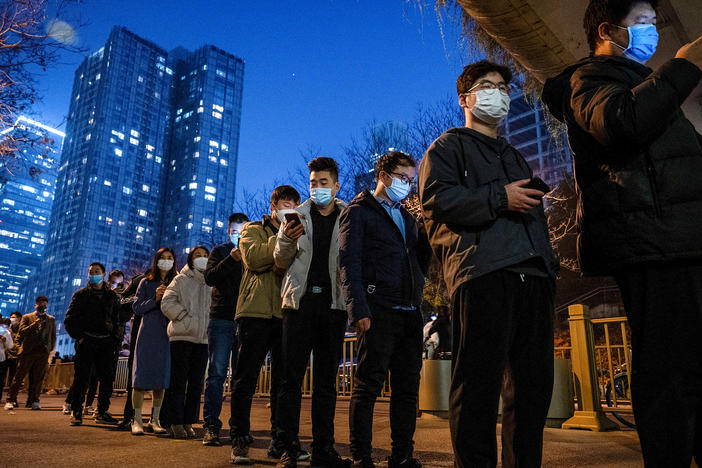 China is doing many millions of tests a day to uncover cases of COVID-19 — part of its zero-COVID policy. Above: People line up for nucleic acid tests to detect the virus at a public testing site on Nov. 17 in Beijing.