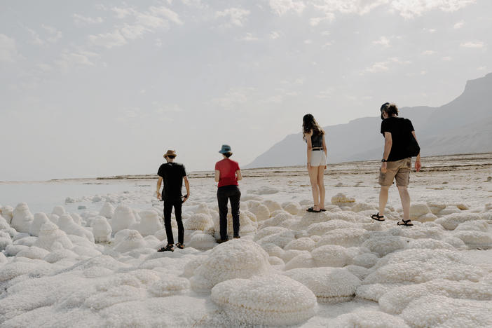 Visitors, including Dead Sea researcher Yael Kiro from Israel's Weizmann Institute of Science (second from left), examine salt formations on the shore of the Dead Sea in Israel on Nov. 5.