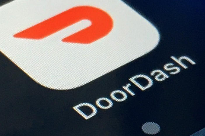 In this Feb. 27, 2020, file photo, the DoorDash app is shown on a smartphone in New York. DoorDash is cutting more than 1,200 corporate jobs, saying it hired too many people when demand for its services increased during the COVID-19 pandemic.