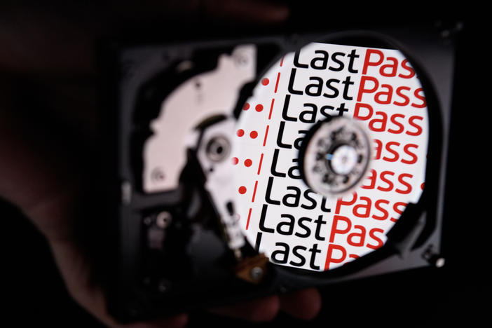 In this photo illustration, the LastPass logo is reflected on the internal discs of a hard drive in 2017 in London. On Wednesday, the password service reported "unusual activity" within a third-party cloud storage service but said that customers' passwords remain safely encrypted.