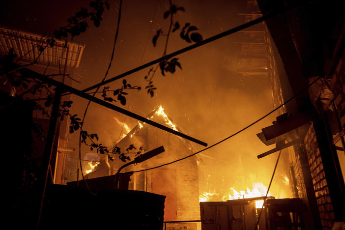 A house burns after a Russian attack in Kherson, Ukraine, Saturday, Dec. 3, 2022.