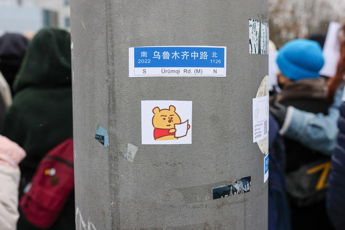 A sticker depicting Winnie the Pooh holding a blank paper was placed on a post as demonstrators protested in front of the Chinese Embassy in solidarity with protesters in China on Saturday in Berlin, Germany.