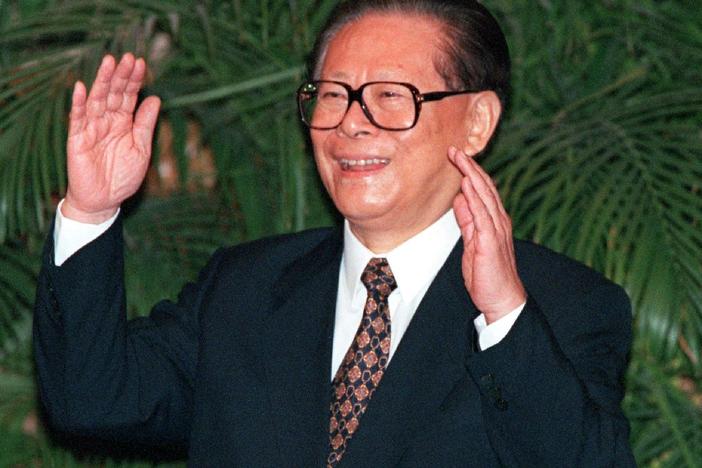 Former Chinese President Jiang Zemin gestures as he thanks reporters for coming to a photo opportunity in Beijing's Great Hall of the People on Sept. 19, 1997. Jiang died on Nov. 30 at age 96.