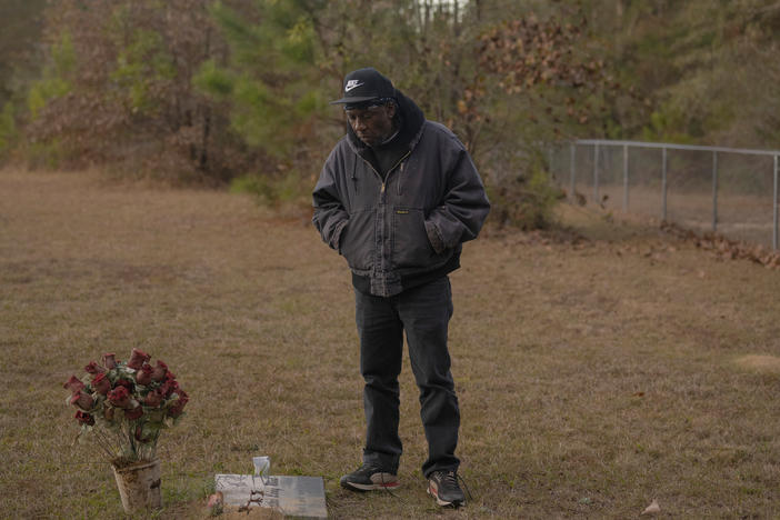 Andy Lang visits the gravesite of his sister Bertha Reed, Sunday November 20, 2022 in McIntosh, Alabama. Lang worked at the Olin Corp. chemical plant as a contract pipefitter, his sister retired after working as a lab analyst. Soon after she retired, Reed, who did not smoke cigarettes, was diagnosed with lung cancer. She died in 2017 at age 64.