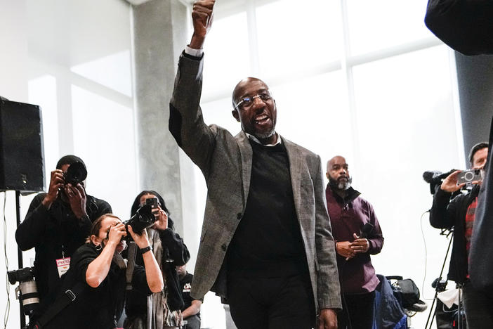U.S. Sen. Raphael Warnock, D-Ga., waves to supporters as he arrives at a campaign rally Monday at Georgia Tech in Atlanta.