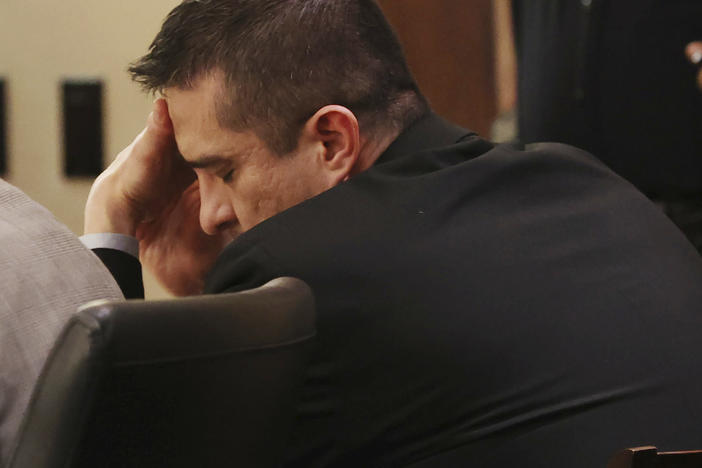 Former U.S. Border Patrol supervisor Juan David Ortiz reacts as recorder jail phone calls to his wife, Daniella, are played outside the presence of the jury during his capital murder trial in San Antonio, Texas, Tuesday, Dec. 6, 2022