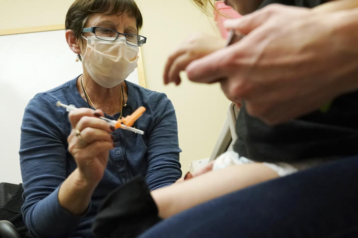 A nurse at a University of Washington Medical Center clinic in Seattle gives a Pfizer COVID-19 vaccine shot to a 20-month-old child on June 21.