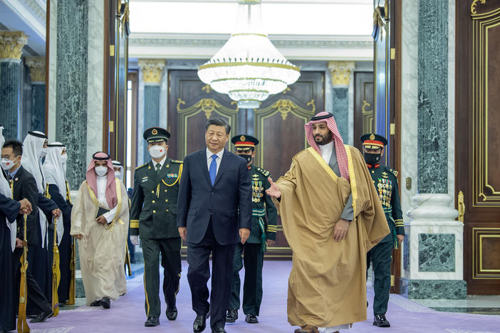 China's leader Xi Jinping (center) walks with Crown Prince of Saudi Arabia Mohammed bin Salman (right), following an official welcoming ceremony at the Palace of Yamamah in Riyadh, Saudi Arabia, on Thursday.