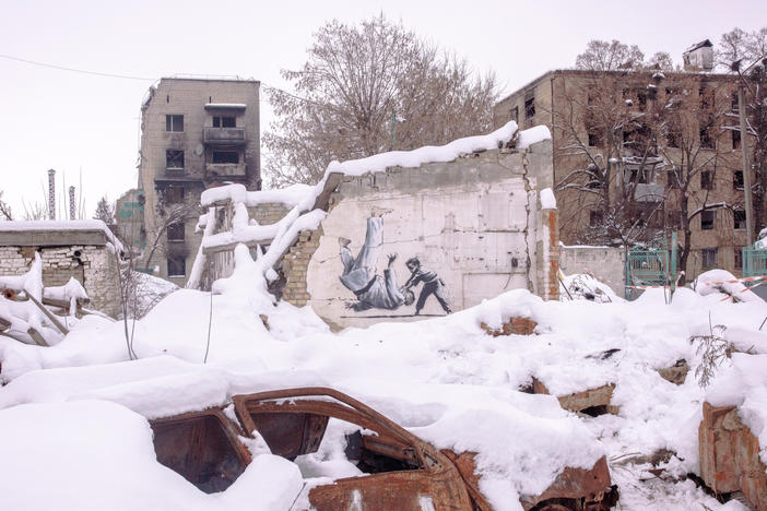 A painting by British street artist Banksy amidst destroyed buildings in Borodianka on Saturday. The image shows a young boy tossing a man to the floor. Both are in martial arts attire. The man is widely assumed to be Russian leader Vladimir Putin, a judo enthusiast.