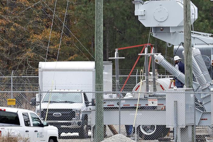 Workers work on equipment at the West End Substation, at 6910 NC Hwy 211 in West End, N.C., Monday, Dec. 5, 2022, where a serious attack on critical infrastructure has caused a power outage to many around Southern Pines, N.C.