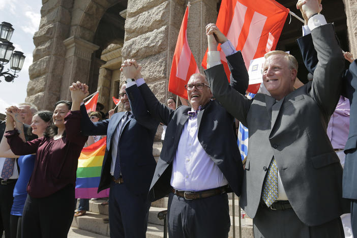Jim Obergefell, the named plaintiff in the Obergefell v. Hodges Supreme Court case that legalized same sex marriage nationwide, center, stands on the steps of the Texas Capitol, Monday, June 29, 2015, in Austin, Texas.