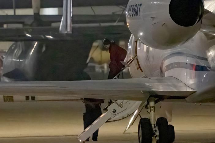 American basketball star Brittney Griner gets out of a plane after landing in San Antonio on Friday.