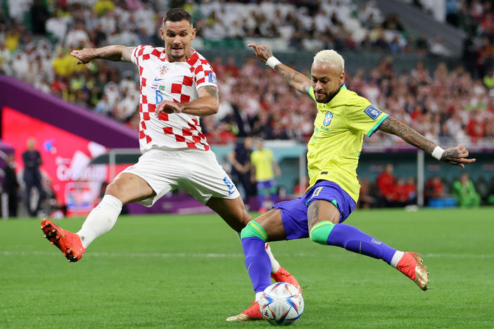 Neymar of Brazil takes a shot against Dejan Lovren of Croatia during the FIFA World Cup 2022 quarterfinal match between Croatia and Brazil at Education City Stadium on December 09, 2022 in Al Rayyan, Qatar.
