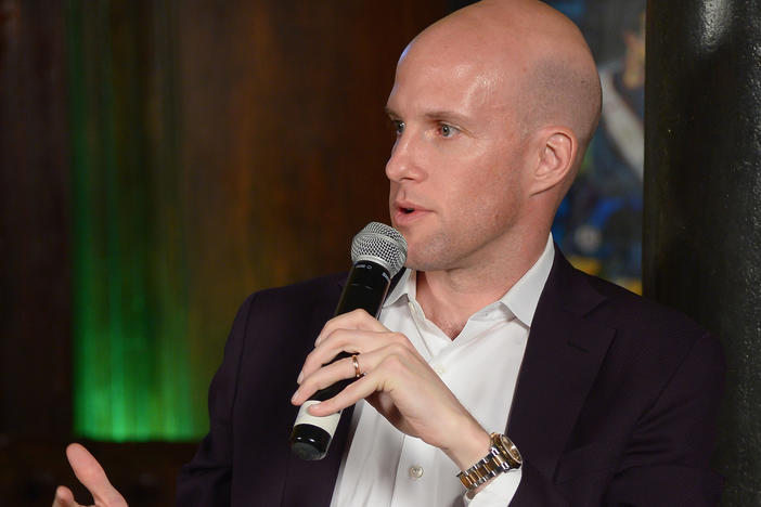 In this file photo, sportswriter Grant Wahl speaks during a panel discussion in New York in 2014. He died Friday in Qatar while covering the Argentina-Netherlands World Cup quarterfinal.