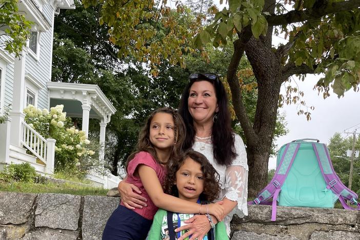 Jennifer Hensel waits for the school bus with her 8-year-old daughter, Imogen, and her 6-year-old son, Owen, on the first day of school this year. They share hugs, kisses, excitement and still some anxiety 10 years after the shooting.