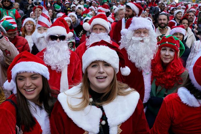 Revellers gather in Times Square for the start SantaCon in New York City on Saturday.