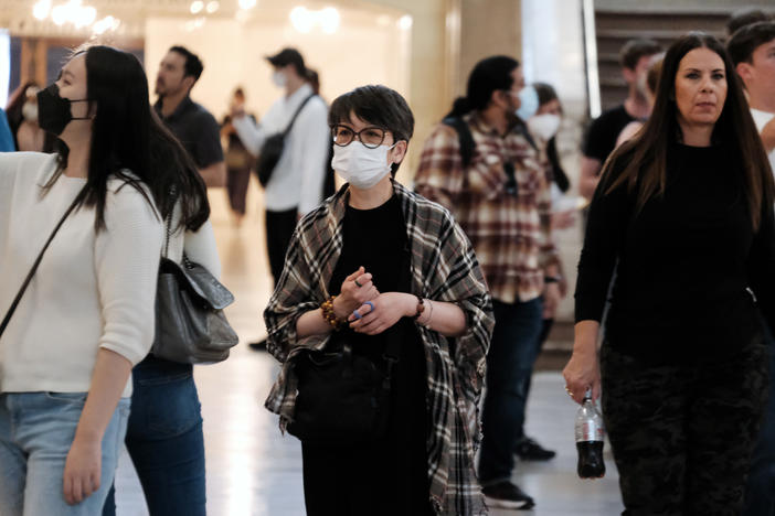 A woman wears a mask indoors in Manhattan earlier this year, in New York City. The city's public health commissioner issued new guidance on Friday advising New Yorkers to wear face coverings in all public spaces.