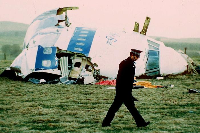 A police officer walks by the nose of Pan Am Flight 103 in a field near the town of Lockerbie, Scotland in 1988.