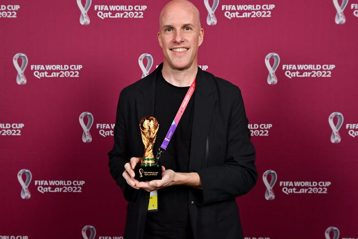 Grant Wahl with a World Cup replica trophy, in recognition of his achievement covering 8 or more FIFA World Cups, during a ceremony at the Main Media Centre on Nov. 29 in Doha, Qatar.