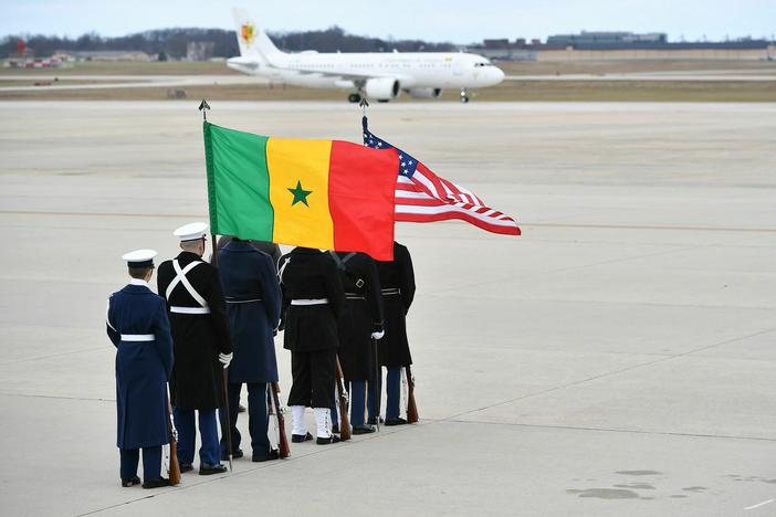 An honor guard watches the airplane carrying Senegalese President Macky Sall land at Joint Base Andrews in Maryland ahead of the U.S.-Africa Leaders Summit on Monday. The summit is taking place this week in Washington, D.C.