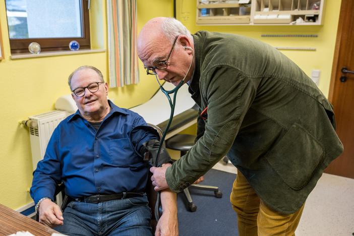 Dr. Eckart Rolshoven examines a patient at his clinic in Püttlingen, a small town in Germany's Saarland region. Although Germany has a largely private health care system, patients pay nothing out-of-pocket when they come to see him.