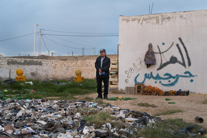 Mohsen Lihidheb stands in the backyard of his museum that is filled with things that he's collected after the waves brought them ashore in Zarzis, Tunisia.