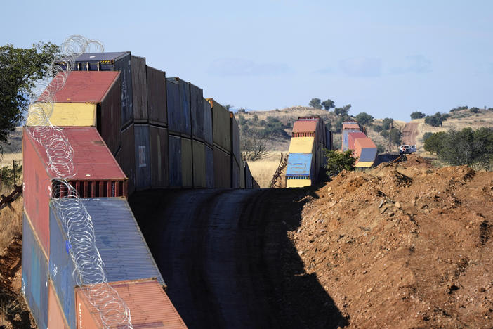 A long row of double-stacked shipping containers provide a new wall between the United States and Mexico in the remote section of San Rafael Valley, Ariz., on Dec. 8, 2022.