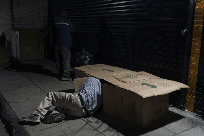 David Hernandez, 62, crawls into his bed made with cardboard boxes in Los Angeles last week. Los Angeles Mayor Karen Bass has declared a state of emergency to grapple with the city's homeless crisis.