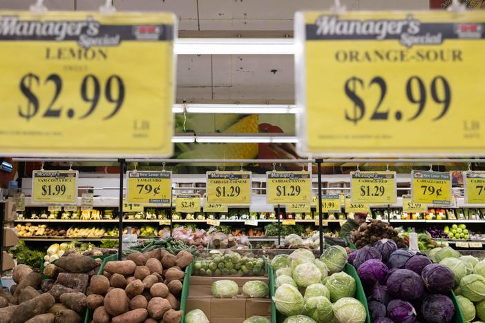 Price tags are displayed at a New York City supermarket  on Dec. 14. Inflation has eased recently, but more evidence is needed to show that price increases are coming down in the long term, Fed Chair Powell said Wednesday.