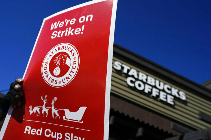 Starbucks employees strike Nov. 17 outside their store in Mesa, Ariz. Starbucks workers around the U.S. are planning a three-day strike starting Friday as part of their effort to unionize the coffee chain's stores.