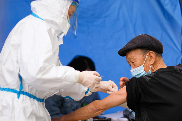 An older adult receives a COVID-19 vaccine at a temporary vaccination site on Dec. 7 in Chongqing, China. Concerns about effectiveness and safety have led to uncertainty about the COVID vaccine, notably among older citizens, whose vaccination rate is relatively low.