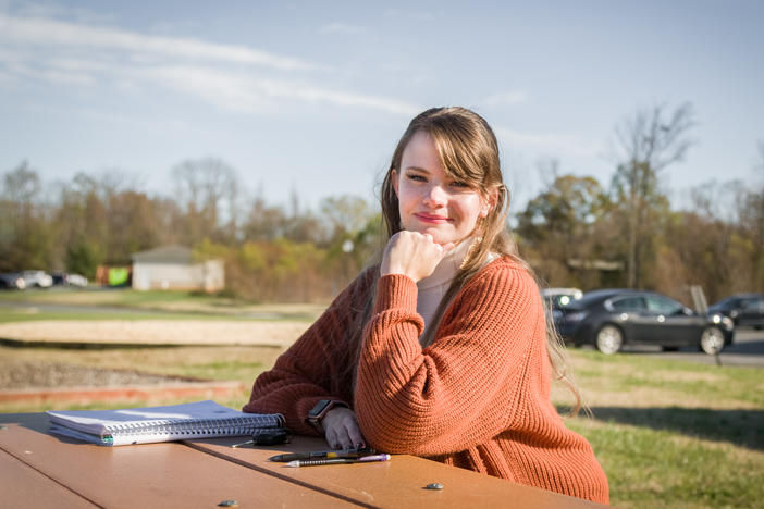 Lauren Overman poses for a portrait at a park close to her home near Greensboro, N.C., on Nov. 21, 2022. Overman will sometimes work virtually from this picnic table as an abortion doula, which she has been doing for over four years. She offers her services virtually and in-person, to people across the U.S., including in states that have banned or severely restricted abortion access.
