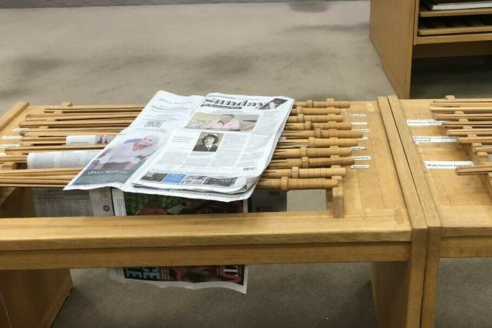 A copy of <em>The Birmingham News</em> rests on a rack at the downtown public library in Birmingham, Ala. The company that runs the newspaper and two sister papers says it will permanently stop print publication after Feb. 26, 2023.