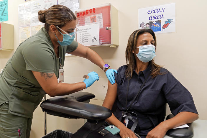 A fourth Pfizer COVID-19 vaccine shot is administered at the Dr. Kenneth Williams Health Center in Los Angeles on Nov. 1.