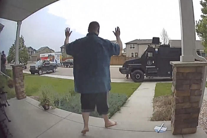 In this image from video, Anderson Aldrich surrenders to police at a home where his mother was renting a room in Colorado Springs, Colo., on June 18, 2021.