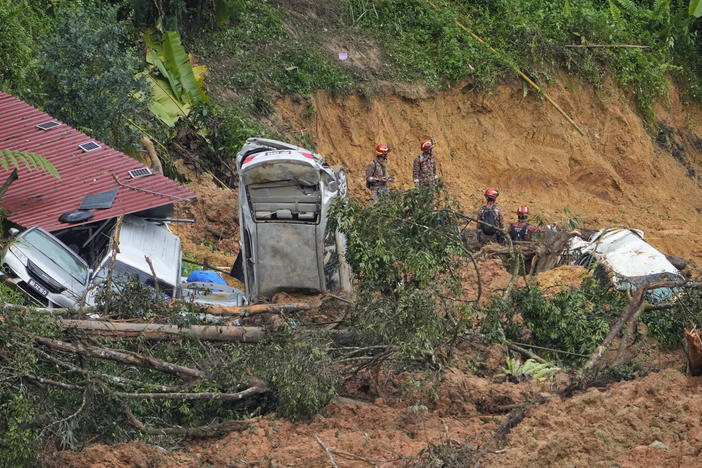 Rescue teams on Saturday continue the search for victims caught in a landslide in Batang Kali, Malaysia.