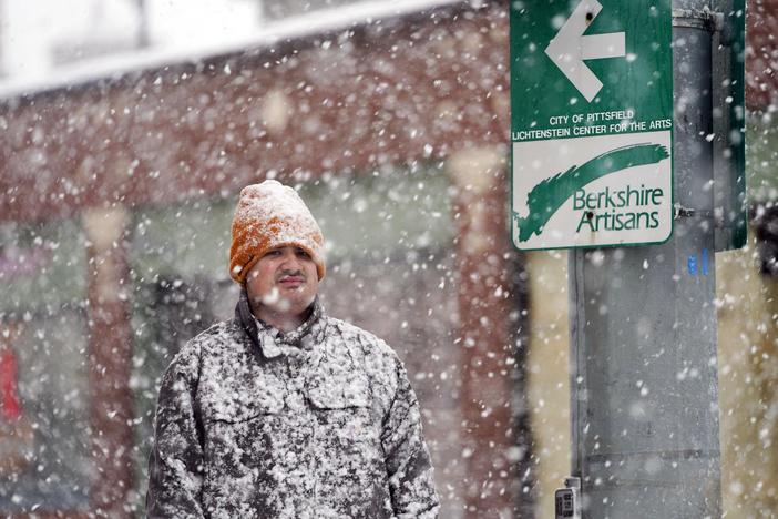 A man is covered in snow on Fenn Street in Pittsfield, Mass., Dec. 16, 2022.