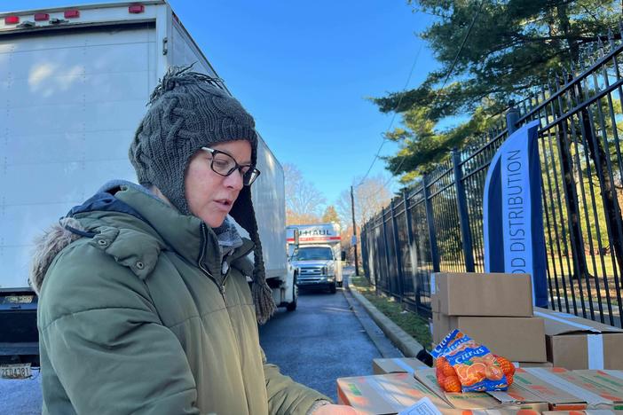 Alysa MacClellan, 47, prepares to send volunteers to their designated drop offs at a food distribution site in Washington, D.C.