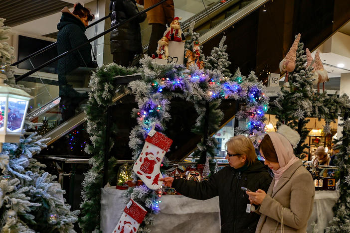 People shop in a mall decorated with winter and Christmas decorations in Kyiv, Ukraine, on Friday.