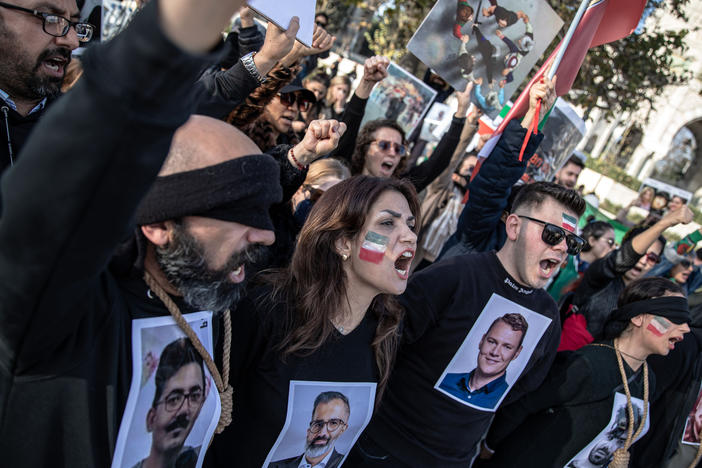 People protest against the Iranian government at a demonstration in Istanbul, Turkey, on Saturday. In recognition of those allegedly executed by the Iranian government, protesters wore nooses around their necks and held photographs of people who have been killed.