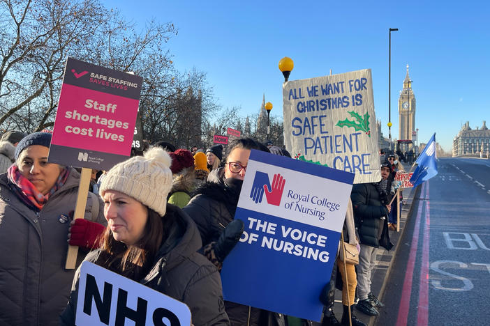 British nurses picket outside St. Thomas' Hospital in London on Thursday. The nurses' union is asking for a 19% pay raise. Nurses, as well as postal workers, rail workers and some airport immigration officers, are staging walkouts over the holiday season. They are asking for pay increases as the U.K. faces nearly 11% inflation.